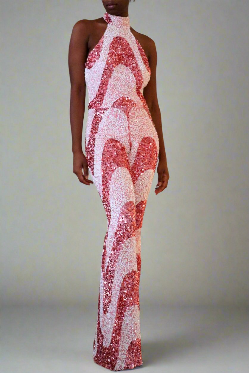 Front side full view of the model wearing pink & white sequin swirl pattern jumpsuit.