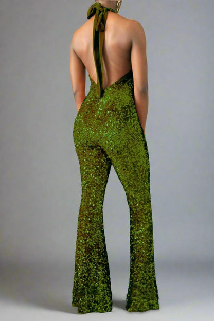 The model is wearing the back view of an olive green sequin halter backless flare leg jumpsuit. 