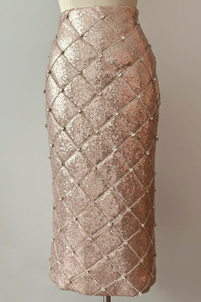 Front of a rose gold quilted sequin skirt with rhinestone embellishment on a diamond quilt pattern 