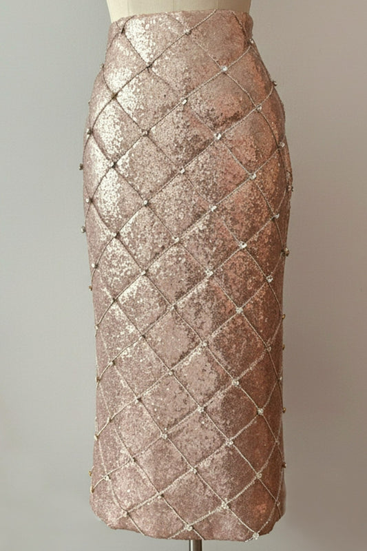 Front of a rose gold quilted sequin skirt with rhinestone embellishment on a diamond quilt pattern 
