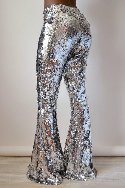 Back view of silver sequin pants on a neutral background