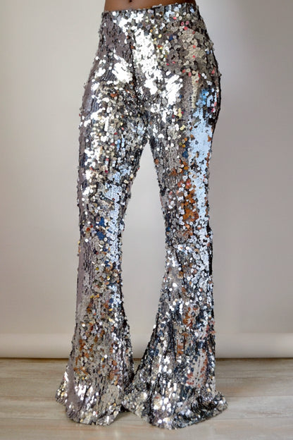 Luxury silver sequin flare pants on a plain background 
