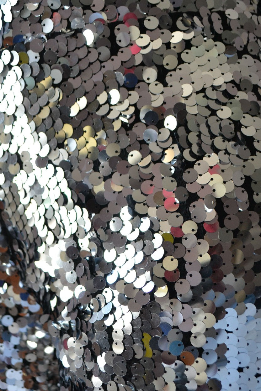 Close-up detail of a silver sequined fabric