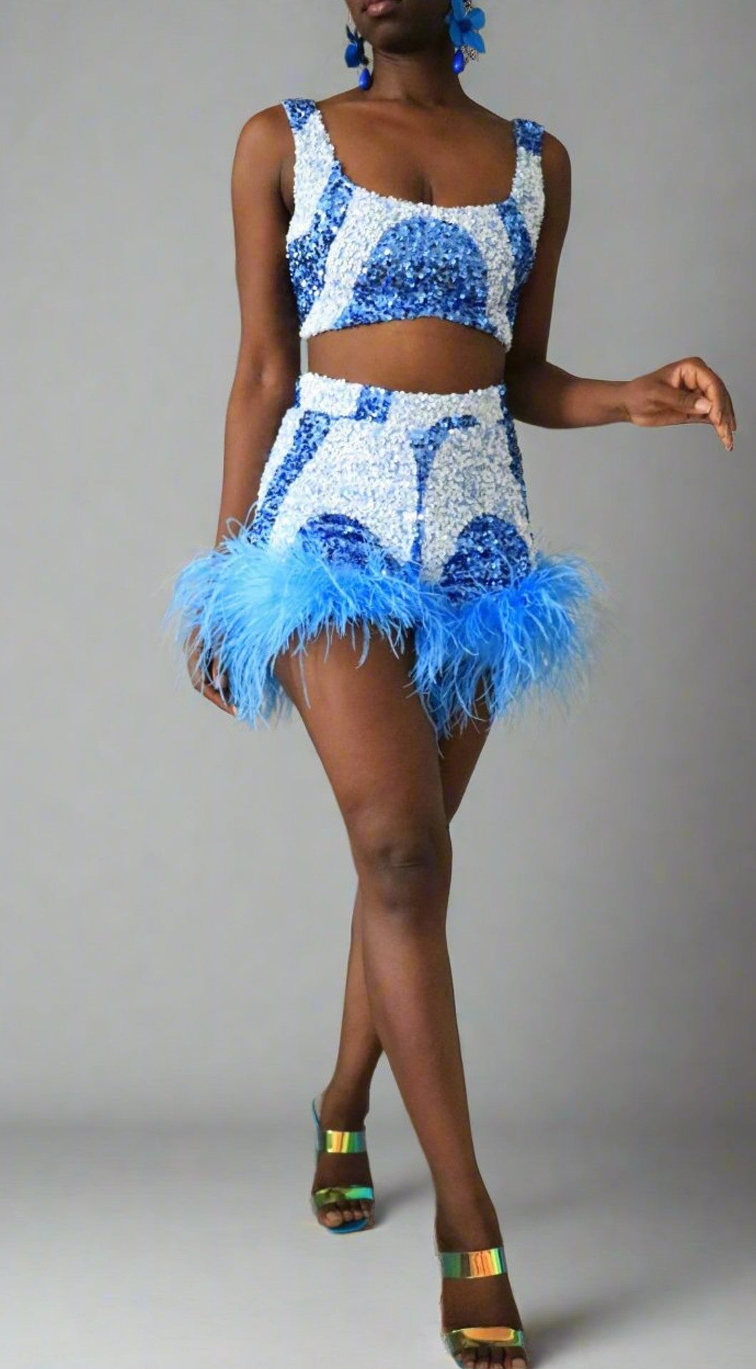 Front view of model wearing blue & white sequin swirl feather shorts with matching square neck crop top