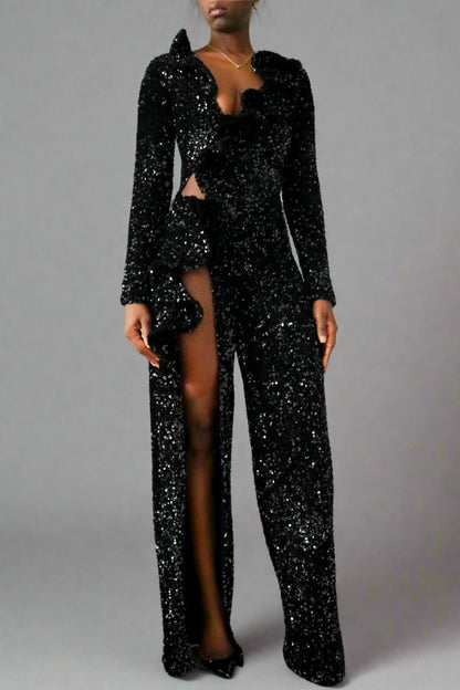 Side Front view of a model wearing Black Sequin Ruffle Long Sleeve Jumpsuit  with a high slit and cutout waist on one side