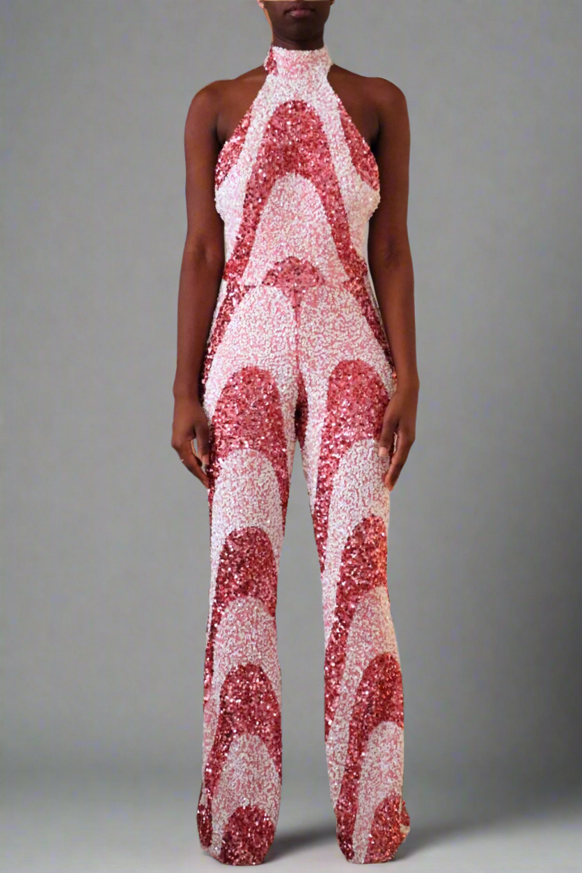Full frontal view of model wearing a Luxury bubblegum pink sequin swirl pattern jumpsuit. 