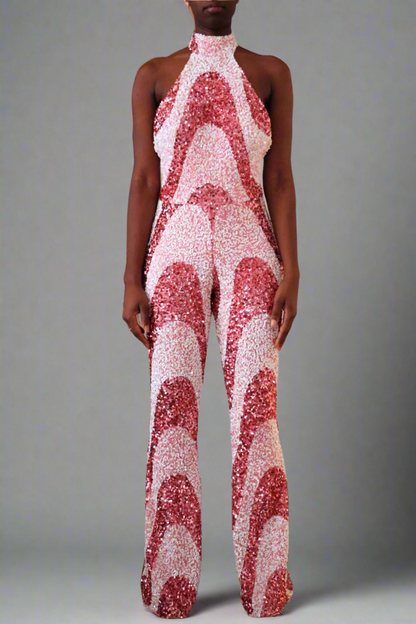 Full frontal view of model wearing a Luxury bubblegum pink sequin swirl pattern jumpsuit. 